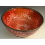 A Bernard Moore red lustre punch bowl, decorated with large leaves on a red ground, metal rim,