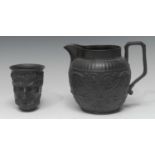 A Wedgwood black basalt Bacchus cup, with vine chaplet, 10cm high, a similar black basalt jug,