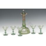 An early 20th century Bohemian green overlaid decanter and glasses,