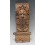 A 19th century oak figural bracket, carved with the head of a bearded gentleman,
