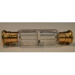 A 19th century French gold mounted clear glass double-ended scent bottle,