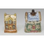 A 19th century cottage money box, with blue roof, sponged in green and pink, 10.5cm high, c.