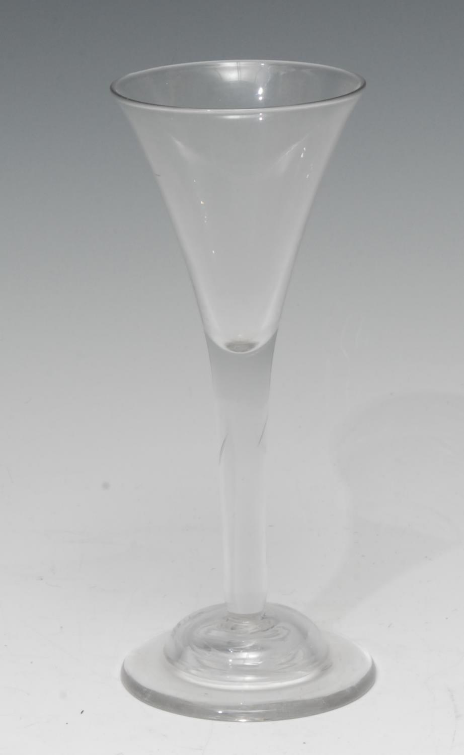 A George III wine glass, quite plain, trumpet-shaped bowl, clear stem, domed foot, slight pontil,