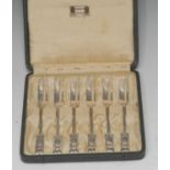 A set of six Honesty pattern cake forks, Archibald Knox for Liberty, London 1928, one fork 1927,