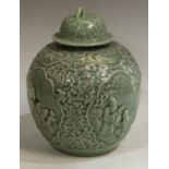 A Chinese celadon ovoid wine jar and cover,