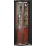 A 19th century mahogany floorstanding bow fronted corner display cabinet,