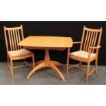 An Ercol elm dining table;