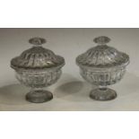 A pair of 19th century Le Creusot clear glass lobed pedestal sweetmeat jars and covers,