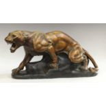 A French Art Deco style model of a snarling panther, the painted plaster body with bronzed effect,