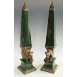 A pair of Jordan ceramic and spelter mounted decorative elephant obelisks, 63cm,