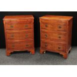 A pair of George III style yew serpentine bachelor's chests,