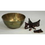 A Chinese brass circular singing bowl, chased with a ferocious dragon and scrolling clouds,