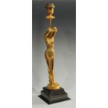 An Art Deco inspired 'gilt' metal figural table lamp, as a nude female, stepped square base, 57.