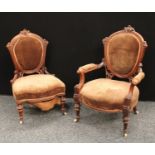 A pair of Victorian mahogany Eastlake style 'his and hers' drawing room chairs (2)