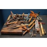 A quantity of vintage tools to include planes, hammers, sharpening stone,