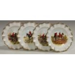 A set of four Royal Crown Derby shaped circular plates printed and painted with huntsmen and hounds,