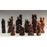 A carved wooden figure of a bearded Priest with dog, others , Elder lamp base; man and child,