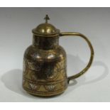 A Middle Eastern silver and copper damascened brass flagon,