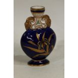 A Derby Crown porcelain miniature flattened ovoid vase, twin rams mask handles,