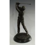 A bronzed metal study, Approaching The Green, a golfer, mid-swing,