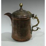 An Islamic Middle Eastern copper flagon, of typical Turkish form, chased overall with figures,