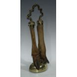 A 19th century brass and taxidermy door porterm shaped carrying handle above two deer hooves and