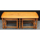 An Ercol elm nested coffee table,