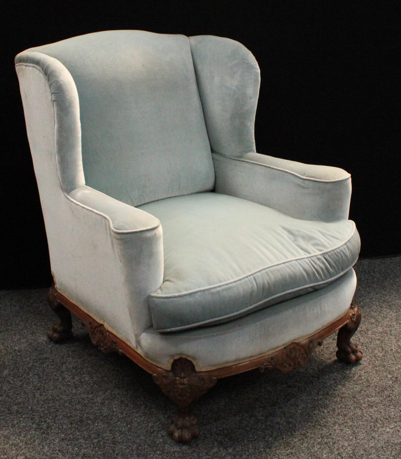 A George II style wingback library chair, of broad and deep proportions,