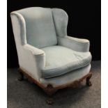 A George II style wingback library chair, of broad and deep proportions,