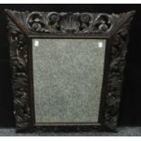 An oak framed looking glass, rectangular mirror plate, carved and pierced frame, 79.