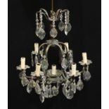 A crystal and lacquered brass seven light six branch ceiling electrolier