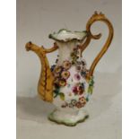 A Rockingham type novelty miniature coffee pot, encrusted with flowers, 16cm high, c.