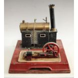 A Bing tinplate tinplate live steam model stationery engine, copper-bound brass tank,