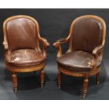 A pair of Victorian oak library armchairs, arched backs, scroll arms, stuffed over upholstery,