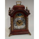 A Franz Hermle burr walnut bracket clock, the arched dial with sun moon phase,
