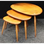 An Ercol elm pebble style nest of three occasional tables, the largest 65.