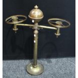 A brass two branch table lamp, the central column crested with an orb,
