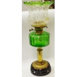 A Victorian oil lamp, everted shade, green glass reservoir,