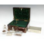 A Victorian rosewood brass mounted work box, fitted with silver plated box, dressing table jars,