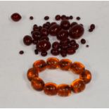 Jewellery - an amber coloured resin ten oval bead bracelet;