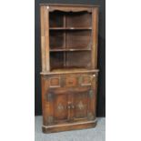 A 17th century style oak floor standing corner cupboard,