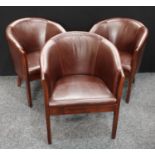 A set of three brown leatherette tub chairs