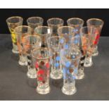 A set of fourteen 1950s/60s lemonade glasses, applied with polka dots in assorted harlequin colours,
