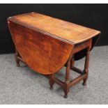 An '18th century' oak gateleg dining table, oval top with fall leaves above a single frieze drawer,