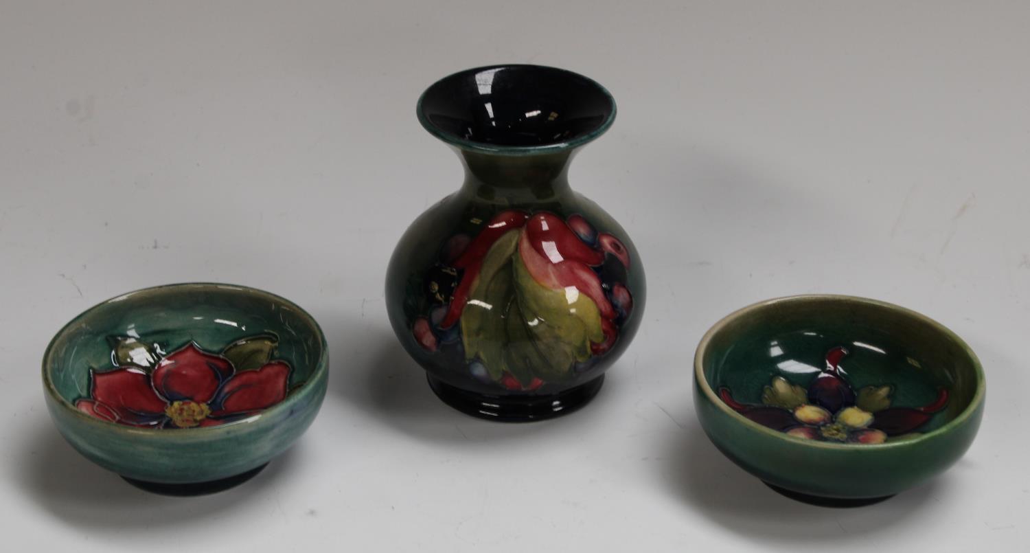 A Moorcroft Leaf and Berries pattern miniature compressed baluster vase, 9cm,