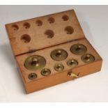 A set of eight graduated brass weights, 20DK - 5g, fitted wooden case,