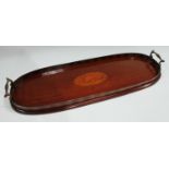 A George III style mahogany butler's serving tray, of narrow proportions, carry handles to sides,