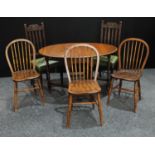 An oak gateleg dining table; a set of three elm country kitchen dining chairs;