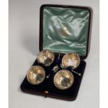 A set of four silver table salts embossed with foliate scrolls, each 4.