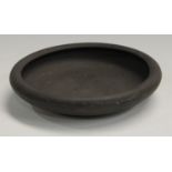 A Wedgwood black basalt circular dish, of plain design, 25.